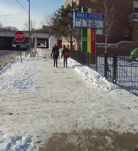 Snow has been only partially cleared from the sidewalk at Bret Harte Elementary. 