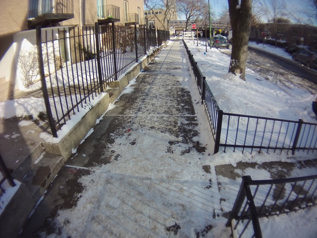 I considered the sidewalk in the middle of this image cleared.  Packed snow along the rest of the sidewalk is not cleared.